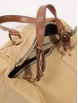Beige leather duffle bag with burgundy stones and brown handles Retail price $1800