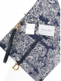 Saddle clutch bag in navy blue and cream toile de Jouy printed canvas and leather Retail price €870