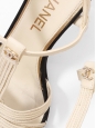 T-bar pumps in cream white leather with black grosgrain and pearl CC logo Retail price €1,200 Size 38