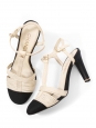 T-bar pumps in cream white leather with black grosgrain and pearl CC logo Retail price €1,200 Size 38