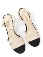 T-bar pumps in cream white leather with black grosgrain and pearl CC logo Retail price €1,200 Size 38
