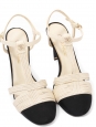 T-bar pumps in cream white leather with black grosgrain and pearl CC logo Retail price €1,200 Size 38